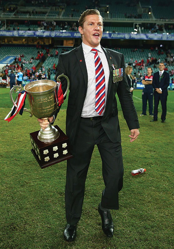 Thomlinson holds the ANZAC Cup after the Sydney Roosters' April 25 victory Over St George Illawarra At Allianz Stadium in 2014.