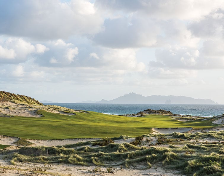 The fairway at the par-4 14th runs down to the ocean, where the putting surface is tucked wonderfully in front of a sand dune, offering views of Hen and Chick Islands in the background.