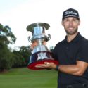 Bryden Macpherson holds trophy on golf course